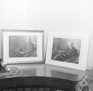 Portraits of Benjamin Hottel on curved bookcase in southwest corner